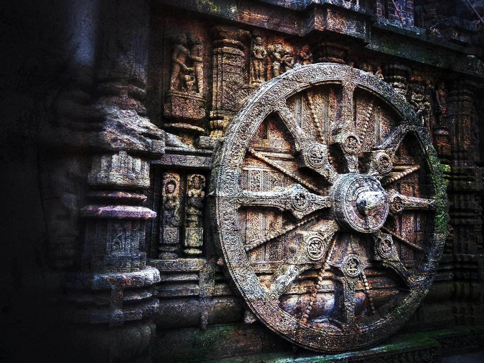 Intricate stone carving of a chariot wheel at the historic Konark Sun Temple, India.